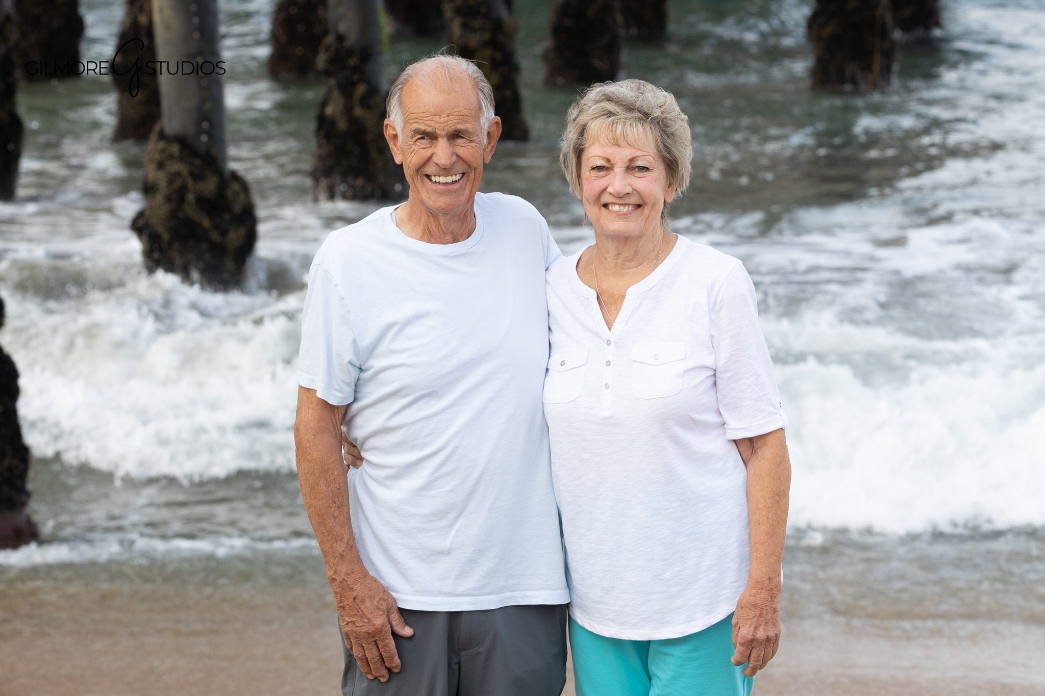 Family photo with ocean waves and rustic pier pilings
Coastal extended family portraits in Newport Beach California
