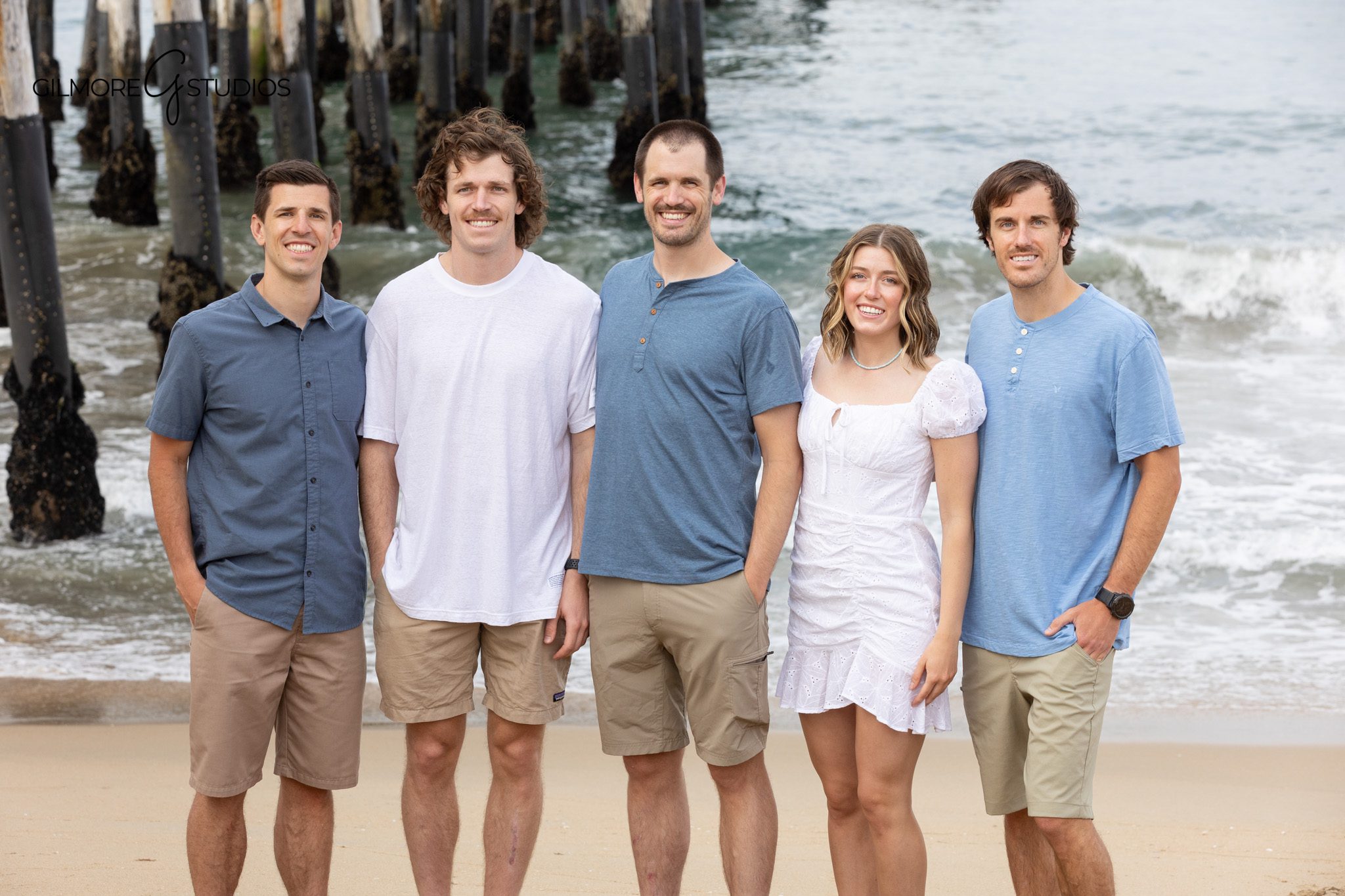 Large family portrait with Newport Beach pier structure overhead
Family posing beneath the wooden pier in Newport Beach
