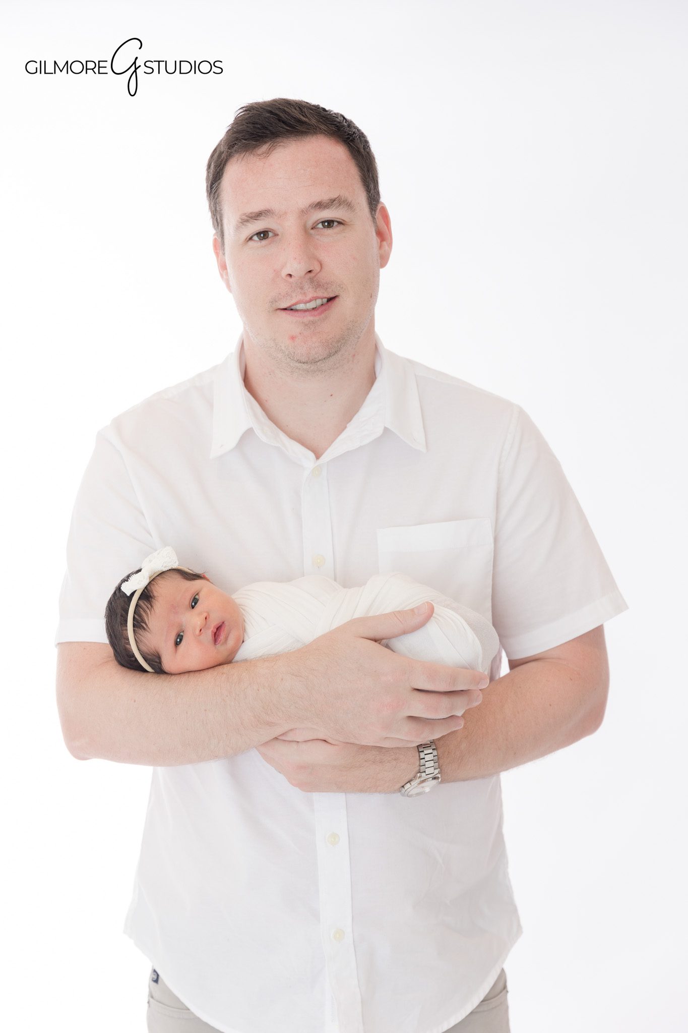 Newborn baby girl with grandma and mom in studio
Three generation newborn portrait with baby girl