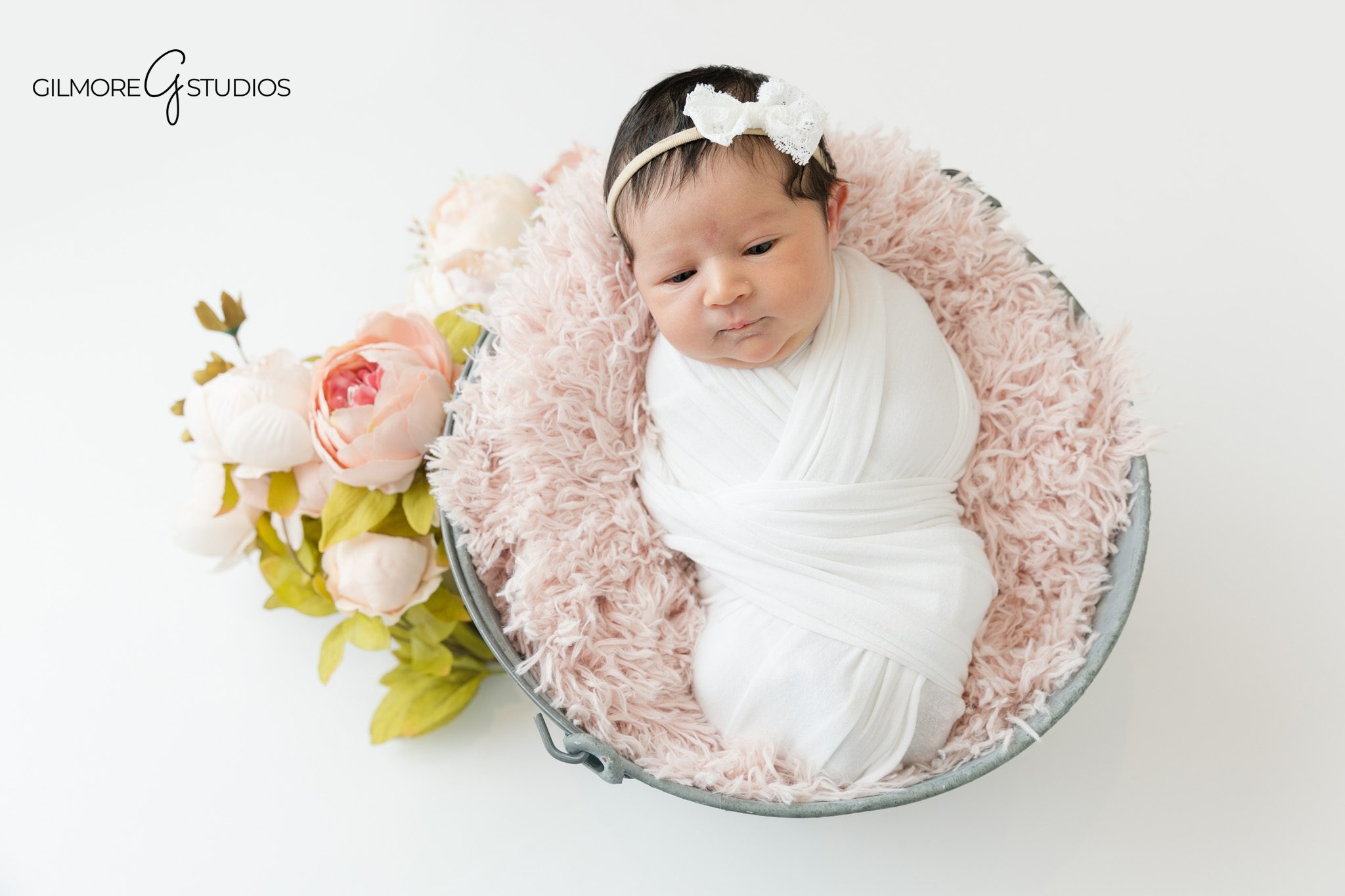 Queen Creek AZ newborn photography with soft white swaddle
Newborn baby girl wrapped in white with parents