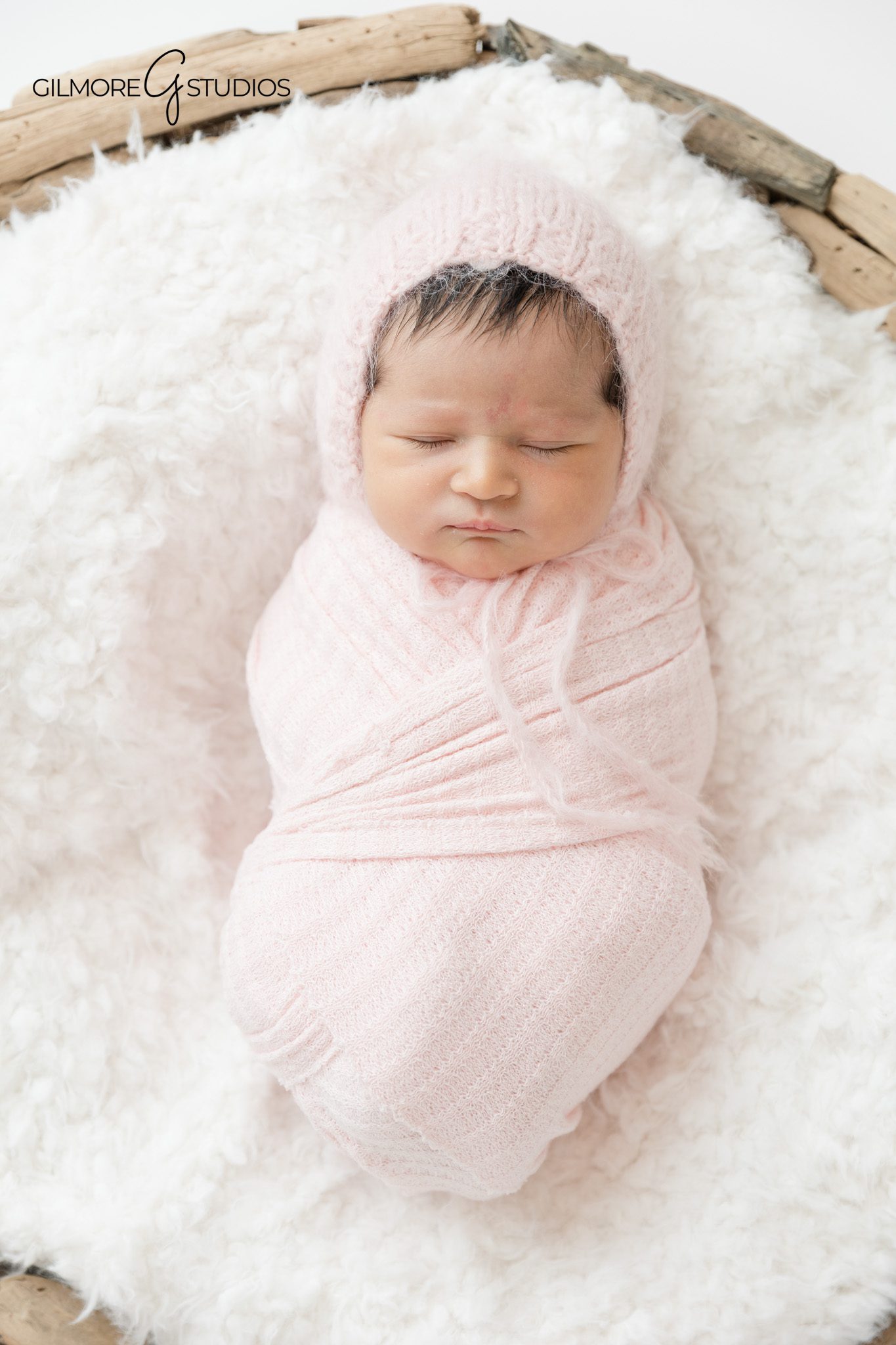 Queen Creek newborn photographer with baby girl floral setup
Newborn baby girl wrapped in blush pink swaddle