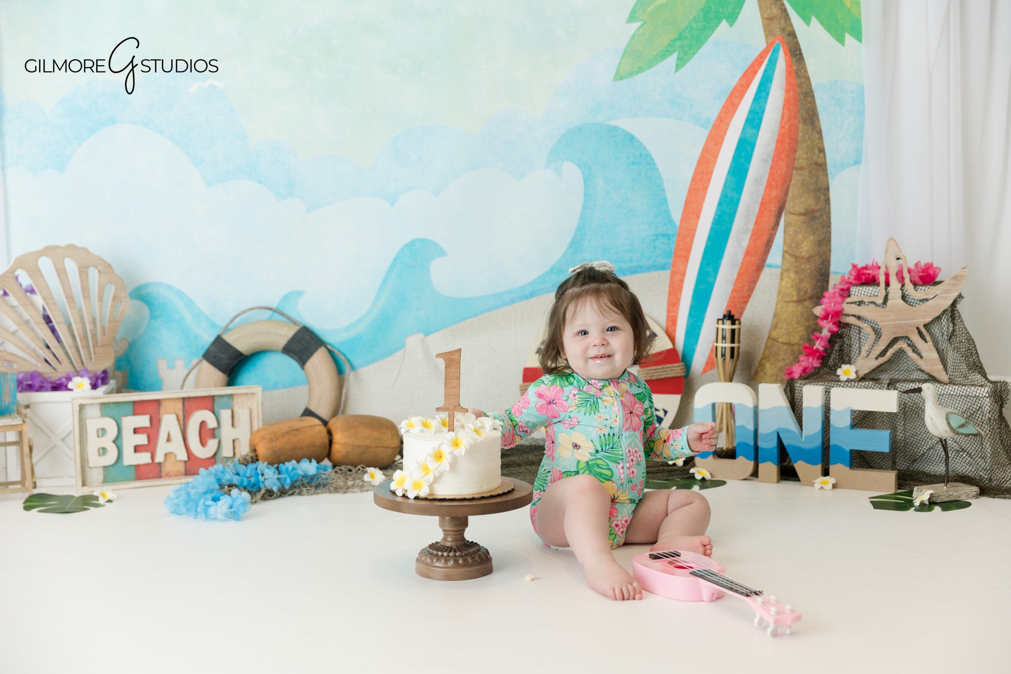 Queen Creek AZ first birthday photographer with coastal cake smash theme
Beach themed cake smash with palm tree surfboard and seashell props