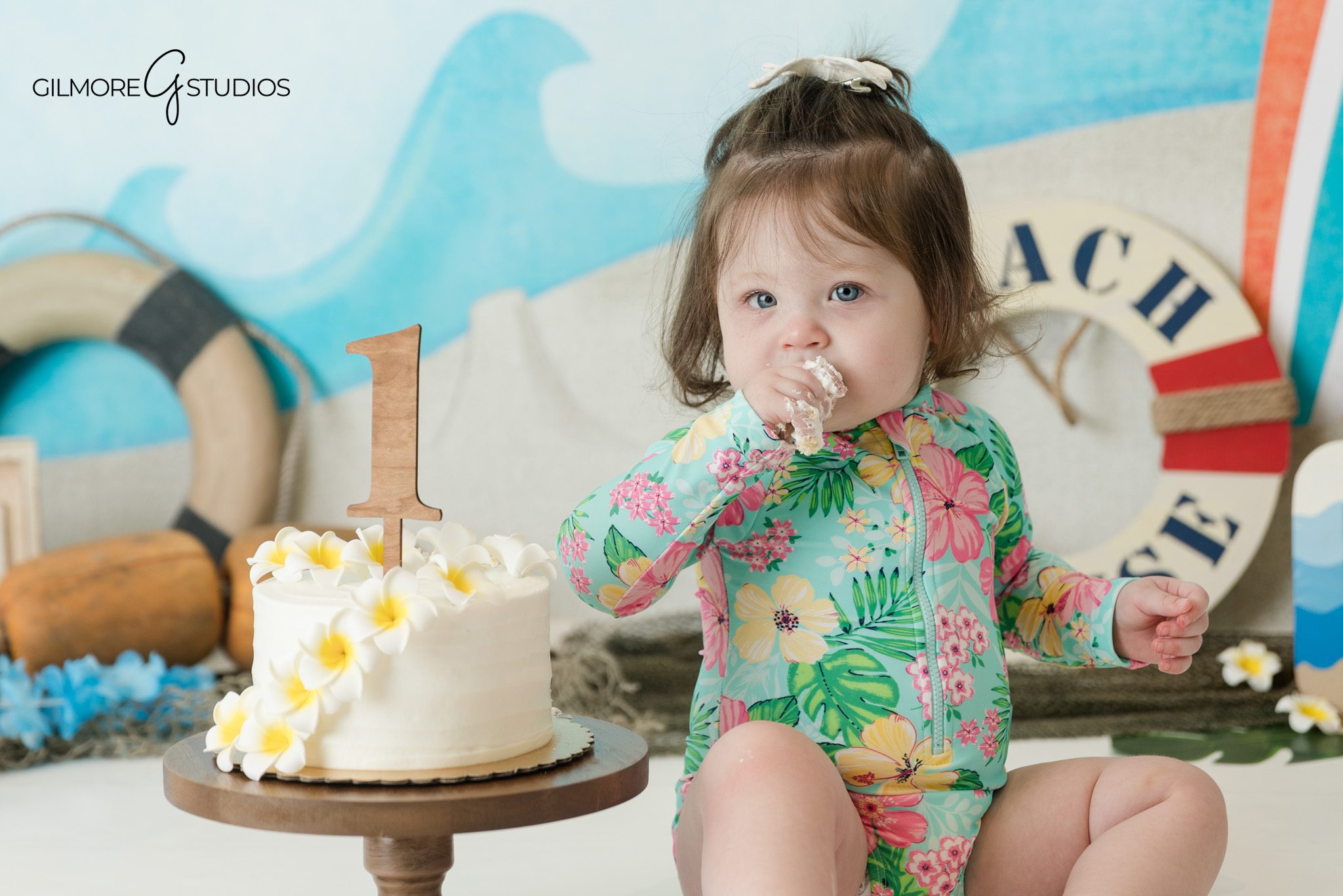 Baby girl beach cake smash with tropical floral swimsuit
Queen Creek cake smash session with surfboard and ocean backdrop