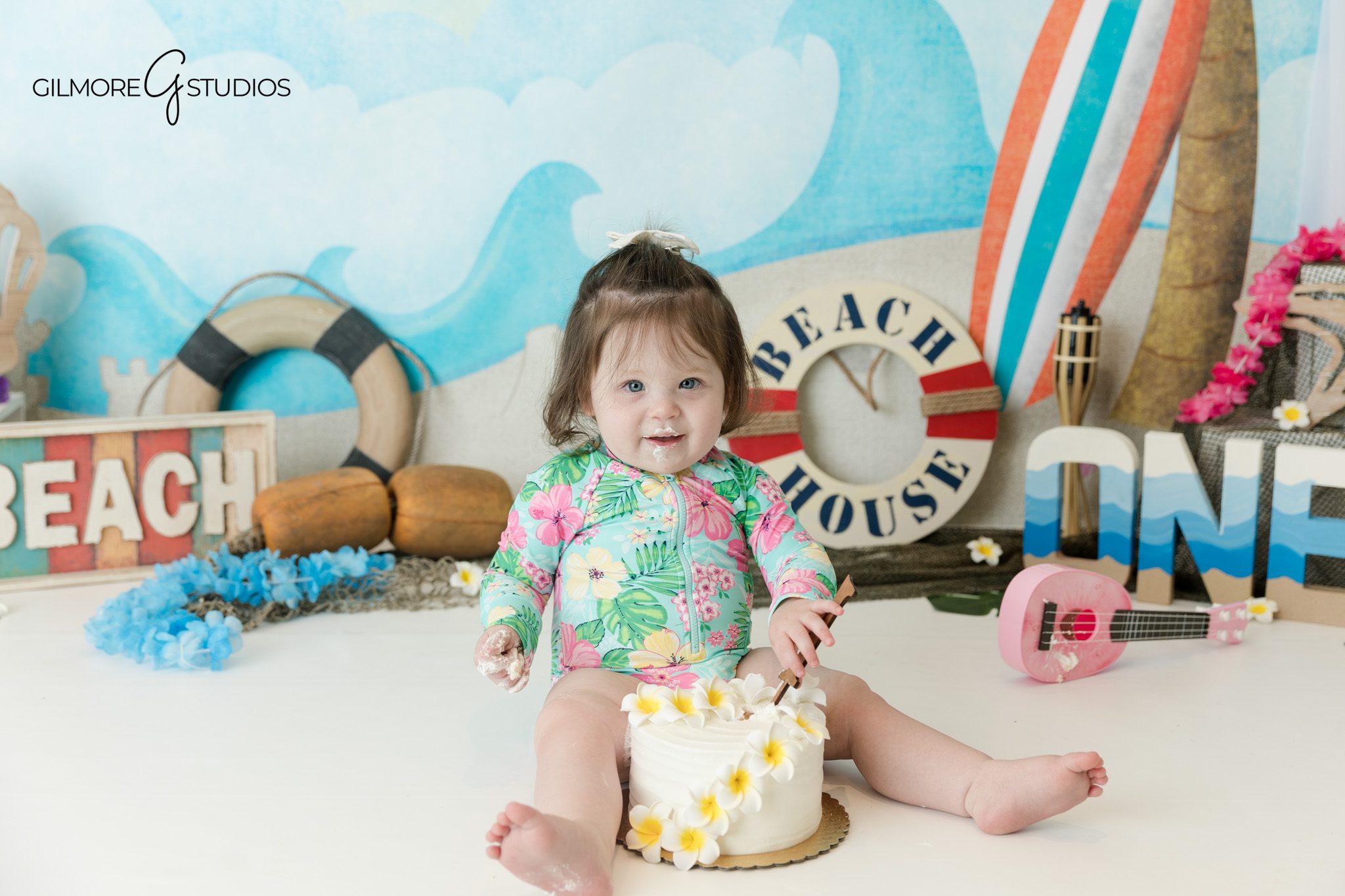 Baby standing by picnic table during first birthday portraits
Mother and baby portrait before beach cake smash session
