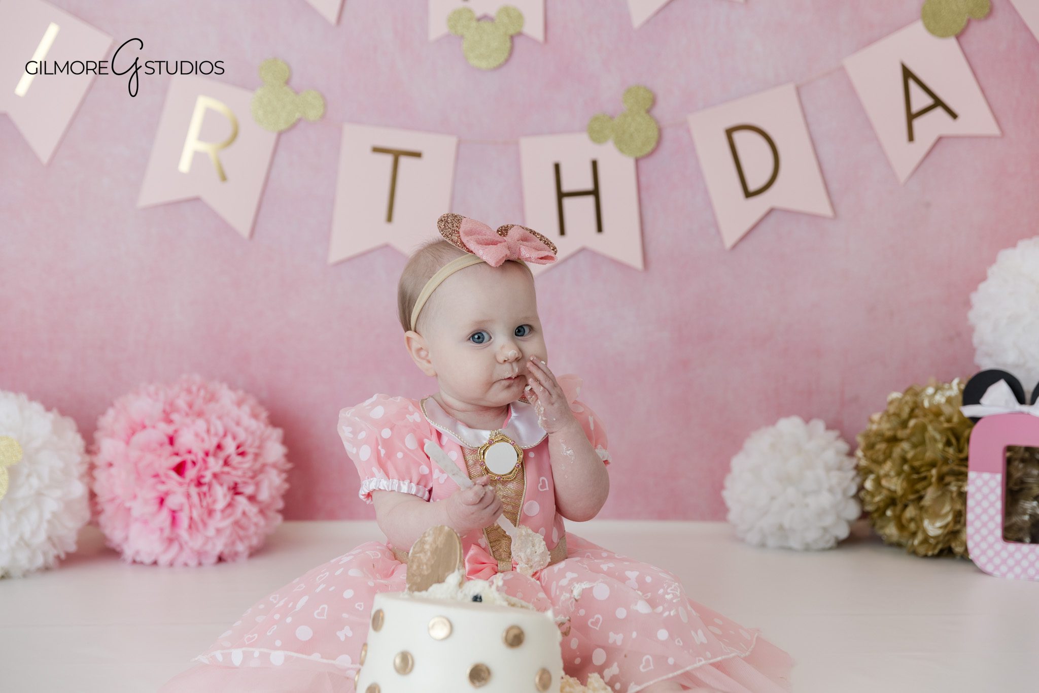 Queen Creek studio cake smash with soft pink birthday theme
Pink Minnie Mouse inspired birthday portraits by Gilmore Studios