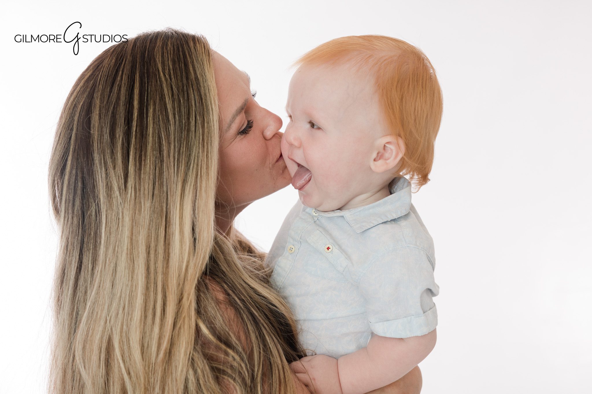 Baby boy sitting barefoot in jeans and blue shirt for first birthday pictures
Queen Creek baby photographer capturing first birthday milestone portraits