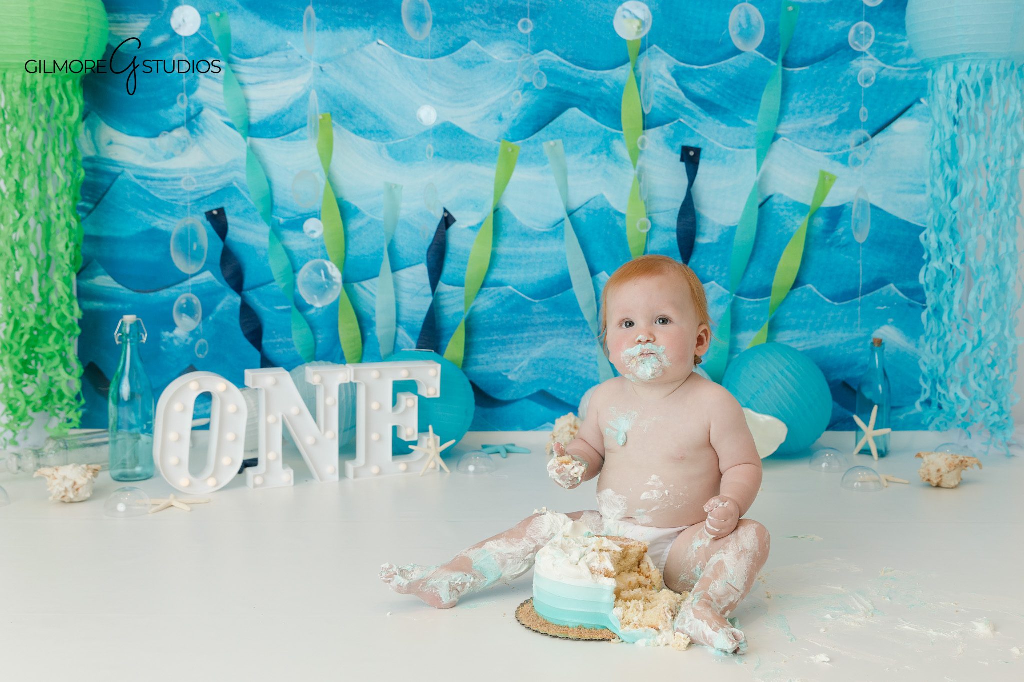 Queen Creek photographer for under the sea boy cake smash session
Baby boy sitting for first birthday portraits on a clean white studio backdrop