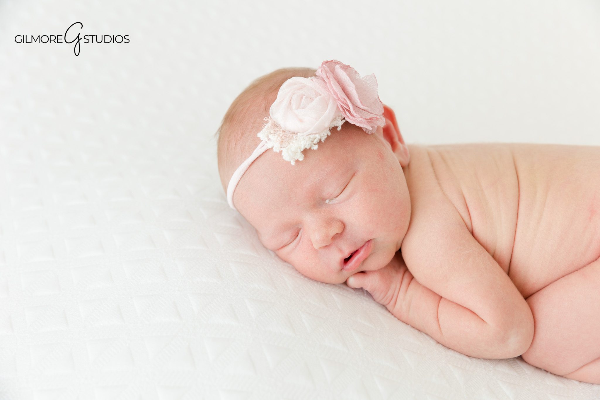 Close up newborn baby face during Queen Creek session
Peaceful newborn portrait with creamy white textures