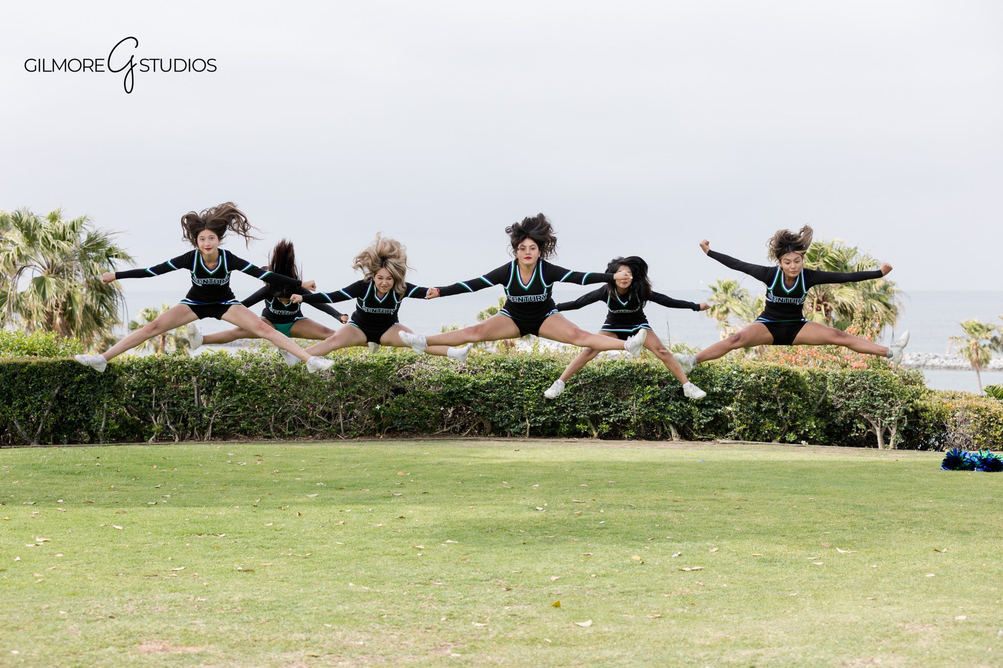 Cheer squad posing together for team photos near the coast
Century High School cheer team portrait with layered group posing