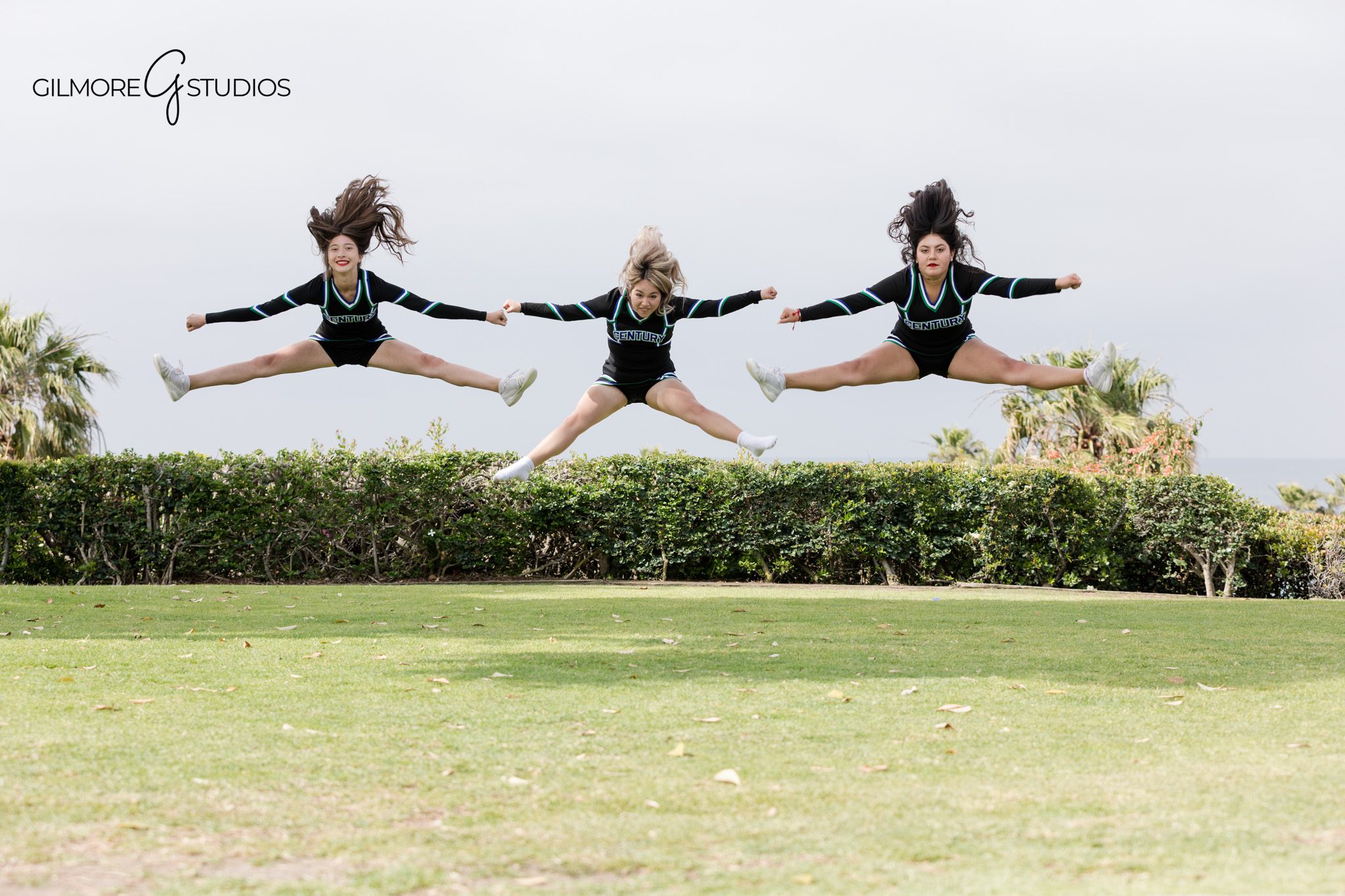 Gilmore Studios cheer team photography in Newport Beach
Cheerleader posing with hands on hips and pom poms