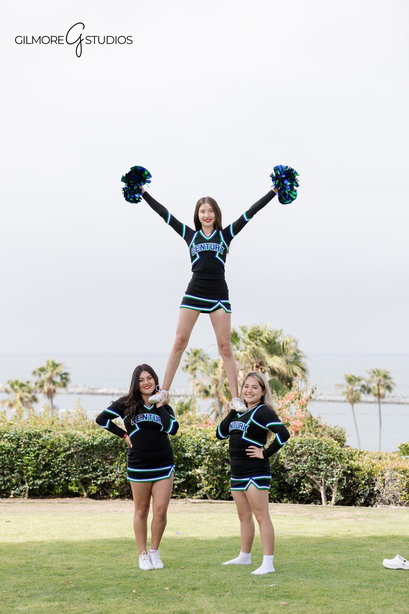 Newport Beach cheer squad portraits with ocean and palm trees
Cheer team group photo on green lawn near the Newport Beach coastline