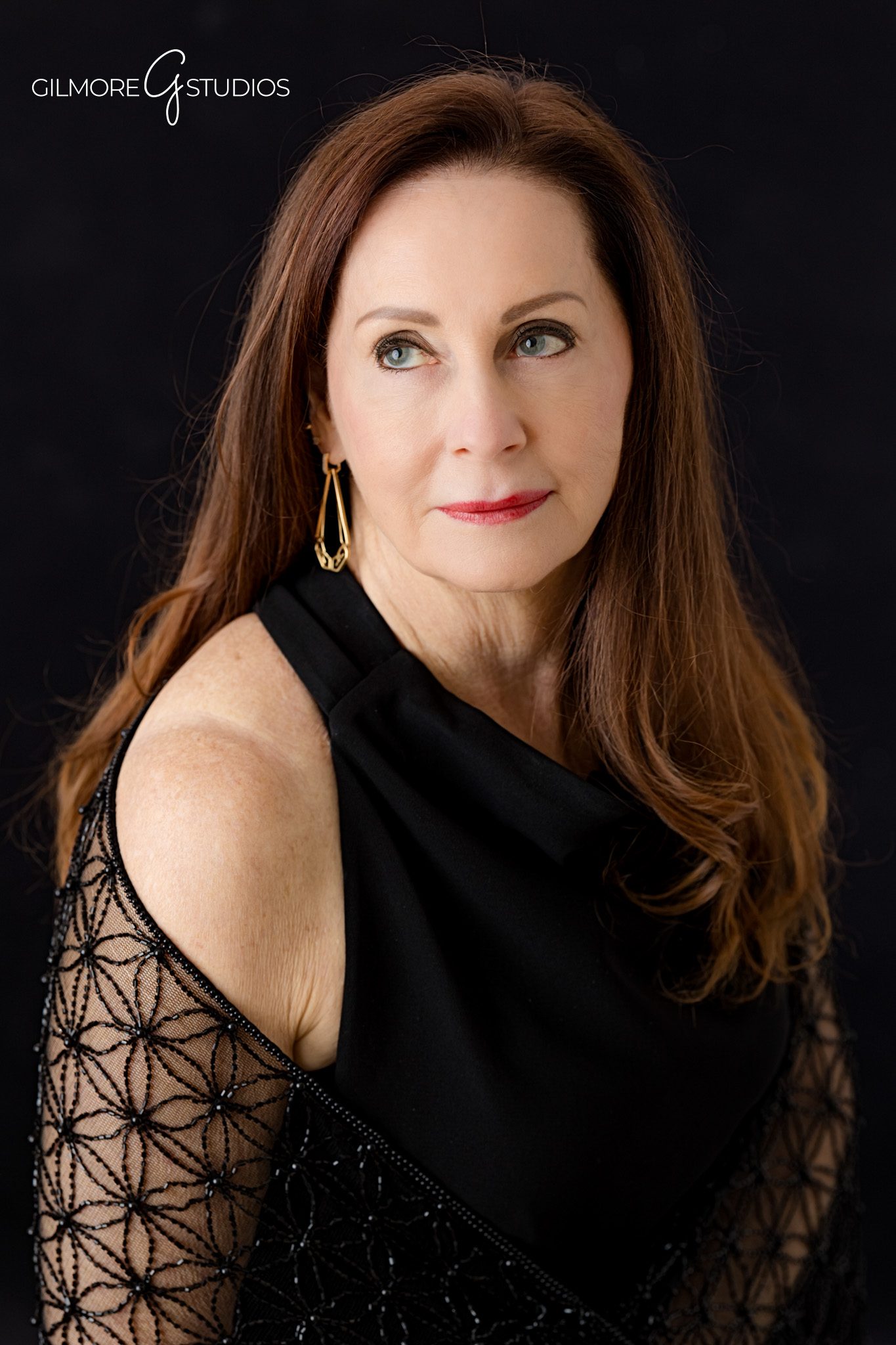Black backdrop studio portrait with flattering light and natural expression
Gilmore Studios headshot photography with classic black background