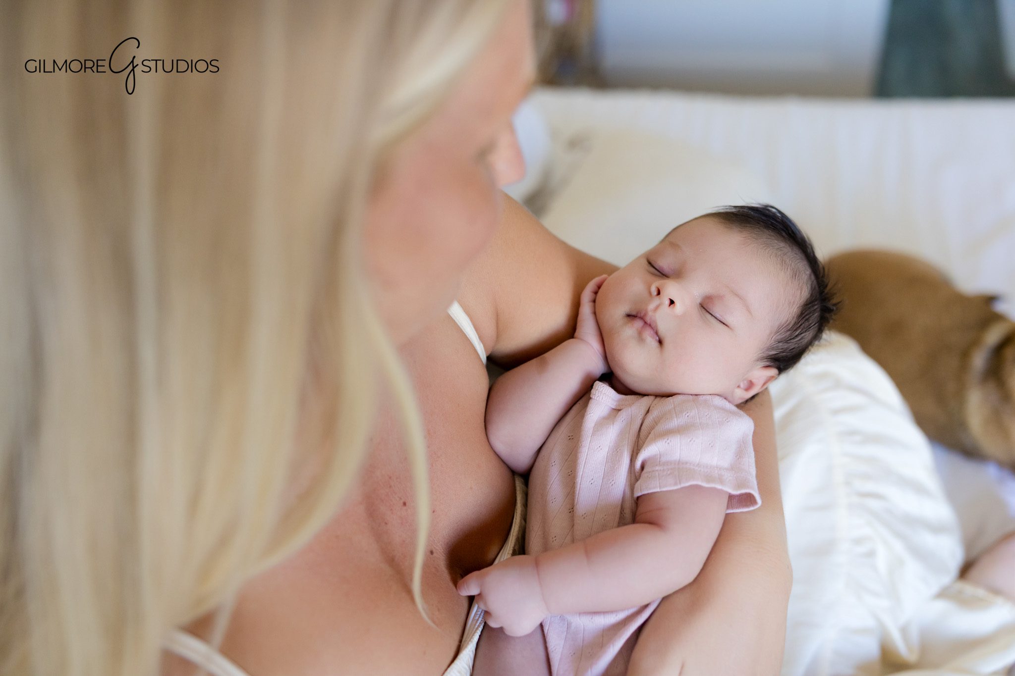 Newborn baby in white swaddle photographed in home nursery
Natural newborn photo of baby girl in a bassinet at home