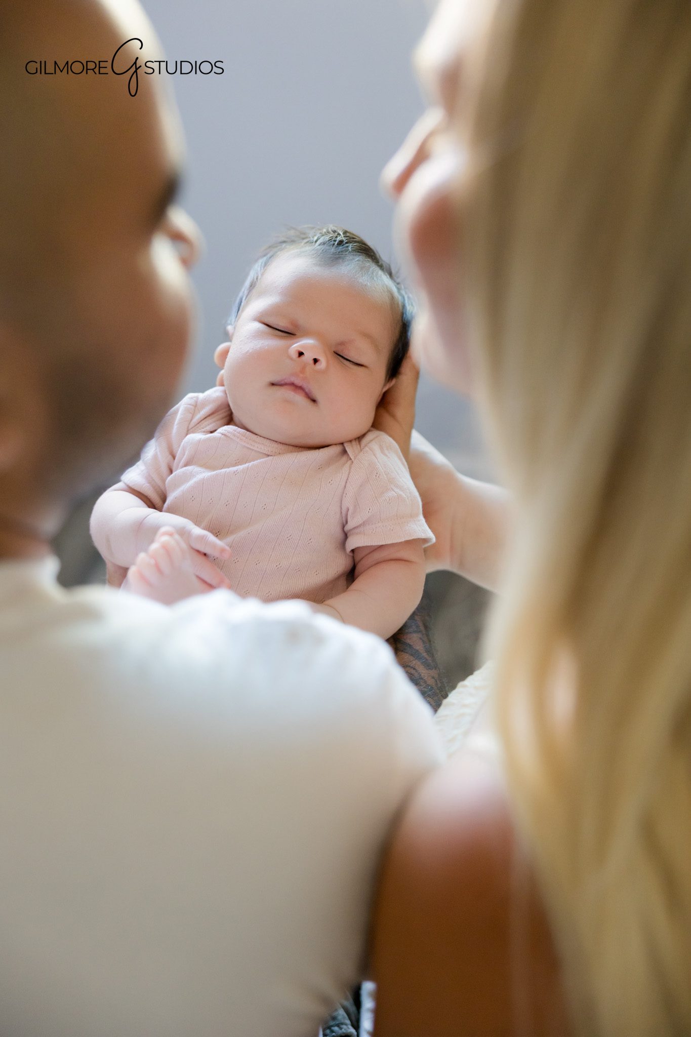 At home newborn session with parents and family dog
Lifestyle newborn photos with mom dad baby and dog in the kitchen