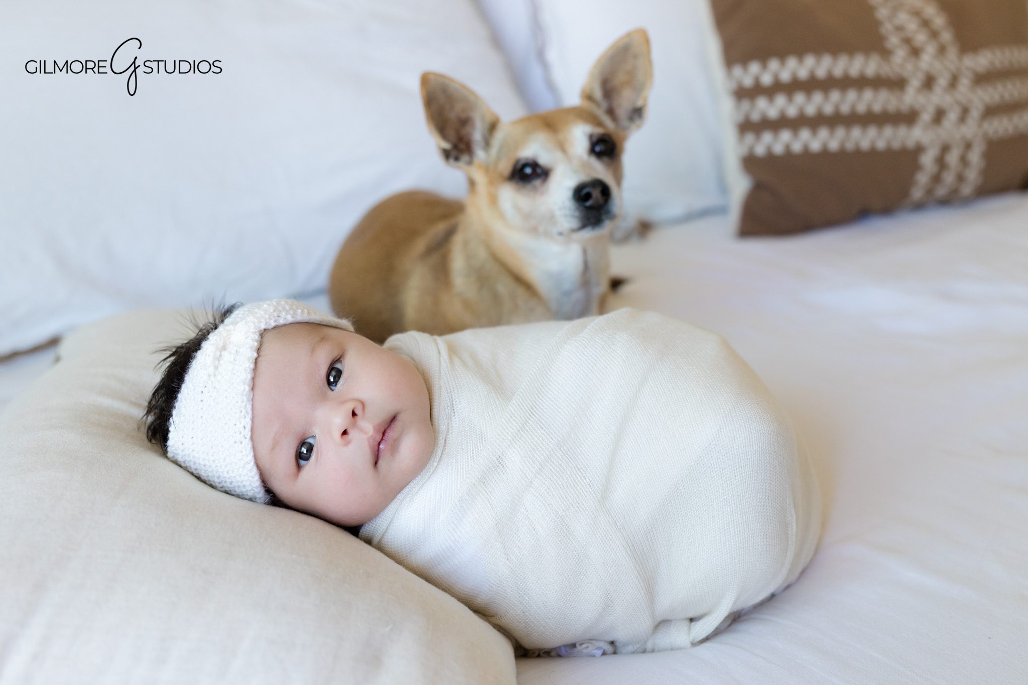 Queen Creek lifestyle newborn photography with soft natural light
Mother holding newborn baby girl on bed during at home session