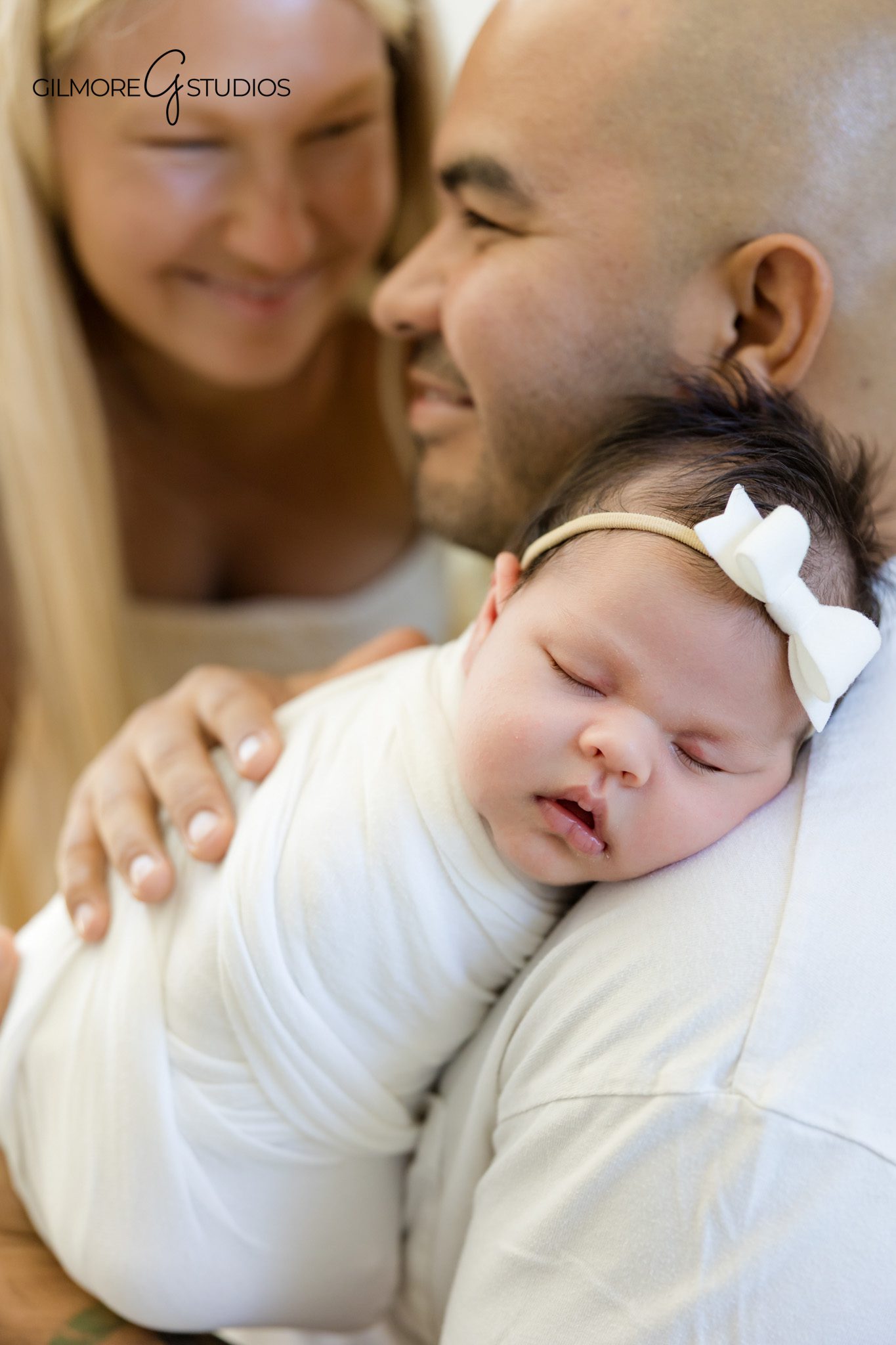 Cozy family newborn portrait inside a bright Queen Creek home
New parents snuggling baby girl during lifestyle newborn photos