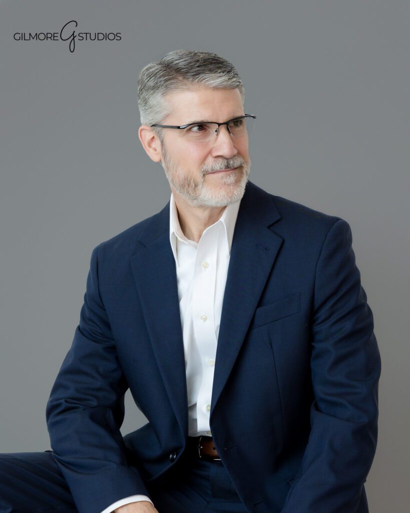 Business portrait of man in navy suit and glasses
Queen Creek AZ professional headshot with polished studio lighting