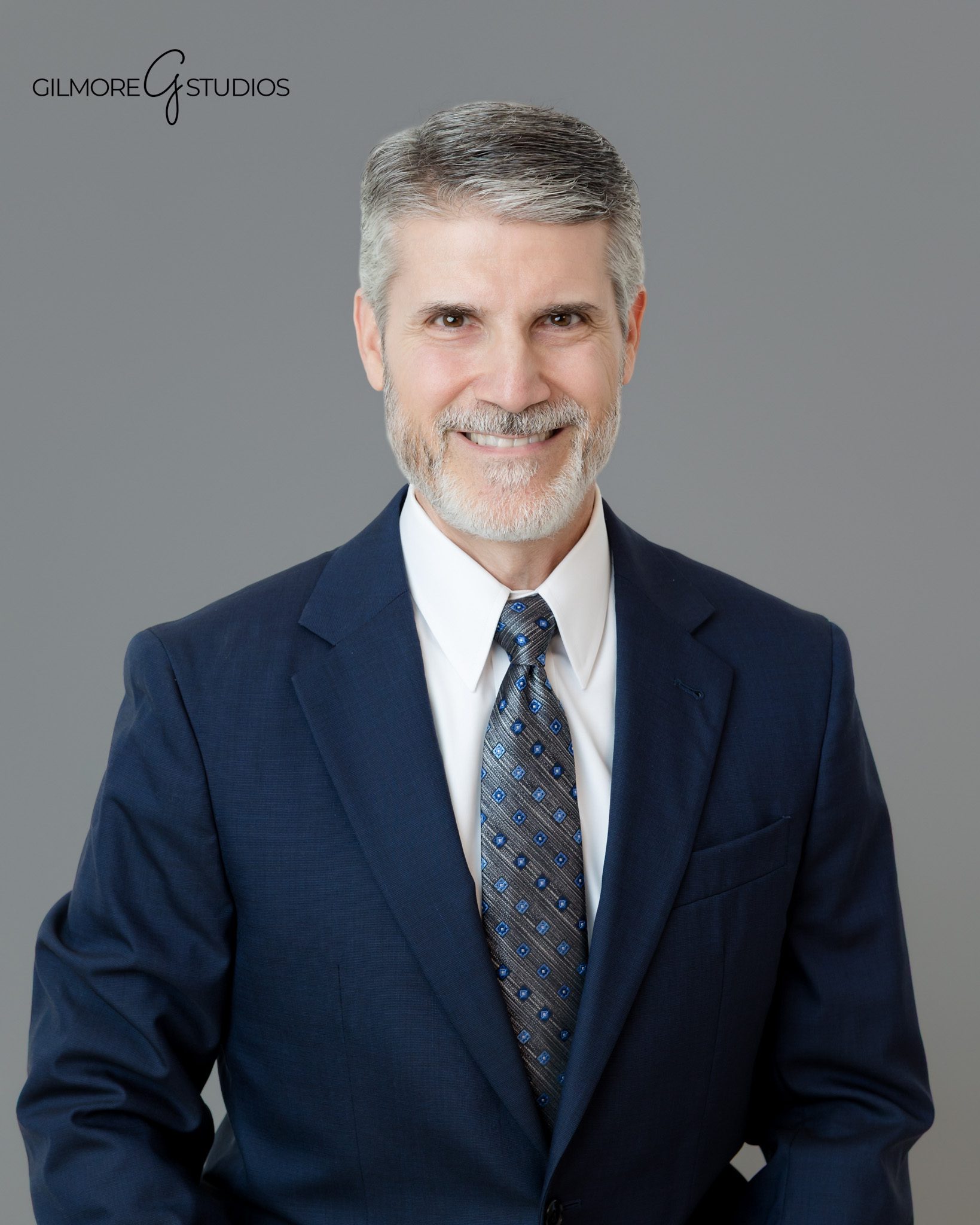 Professional portrait of man seated in navy suit
East Valley AZ headshot photographer for business professionals