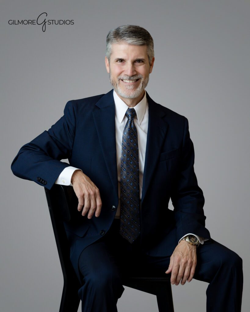Gray backdrop studio portrait for corporate website
Individual business headshot with confident expression