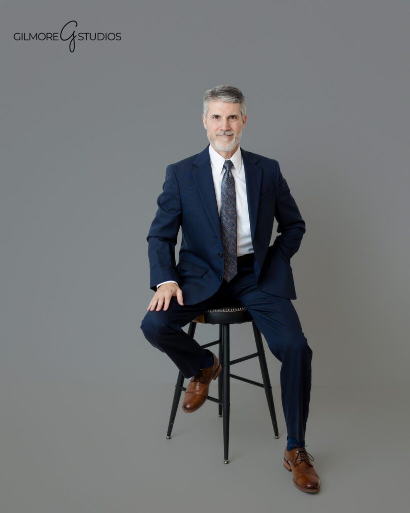 Men’s headshot photography with classic suit and gray backdrop
Professional portrait for company website and LinkedIn profile