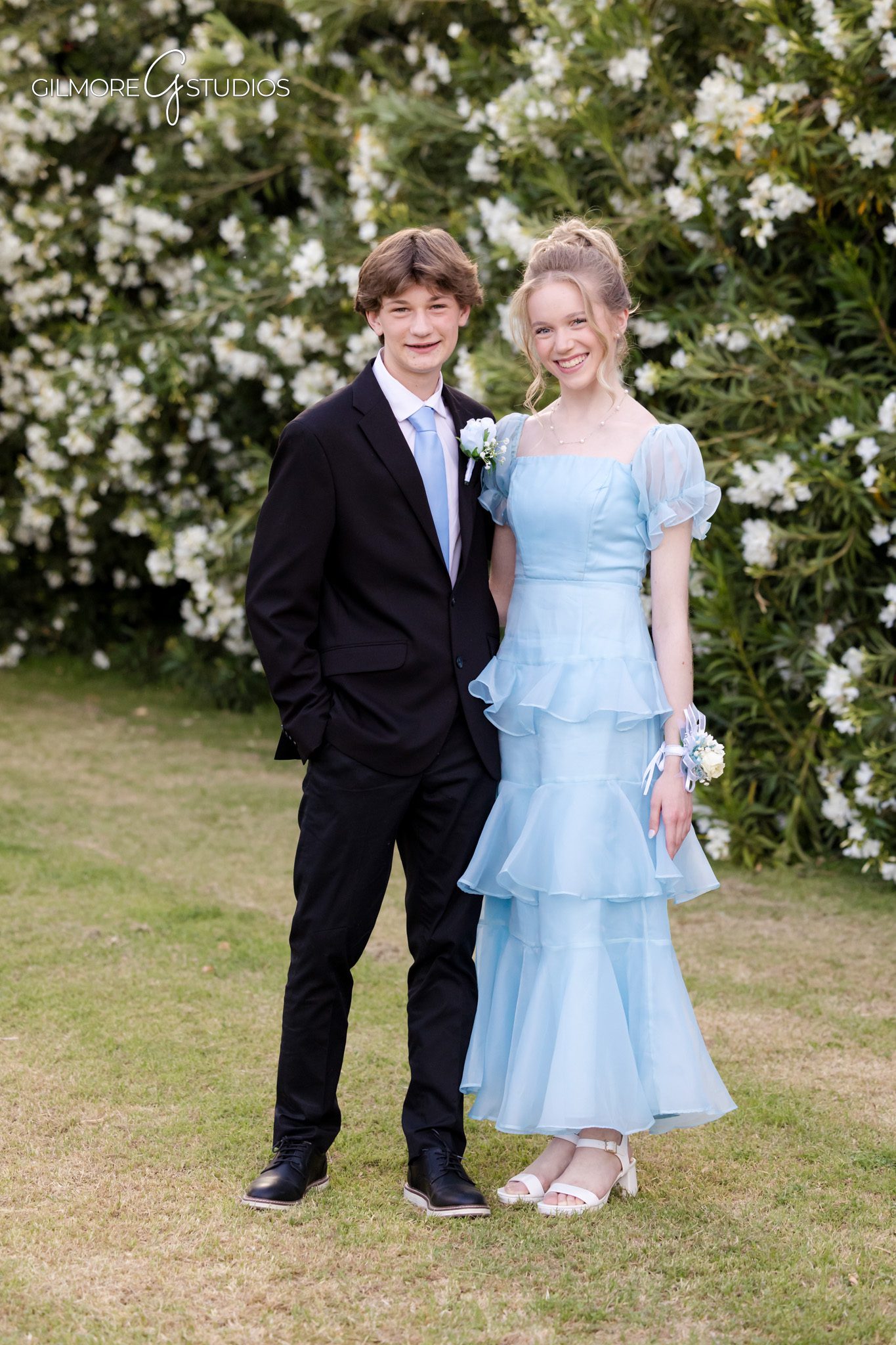 Teen prom couple smiling in outdoor garden setting
Gilbert prom couple walking hand in hand