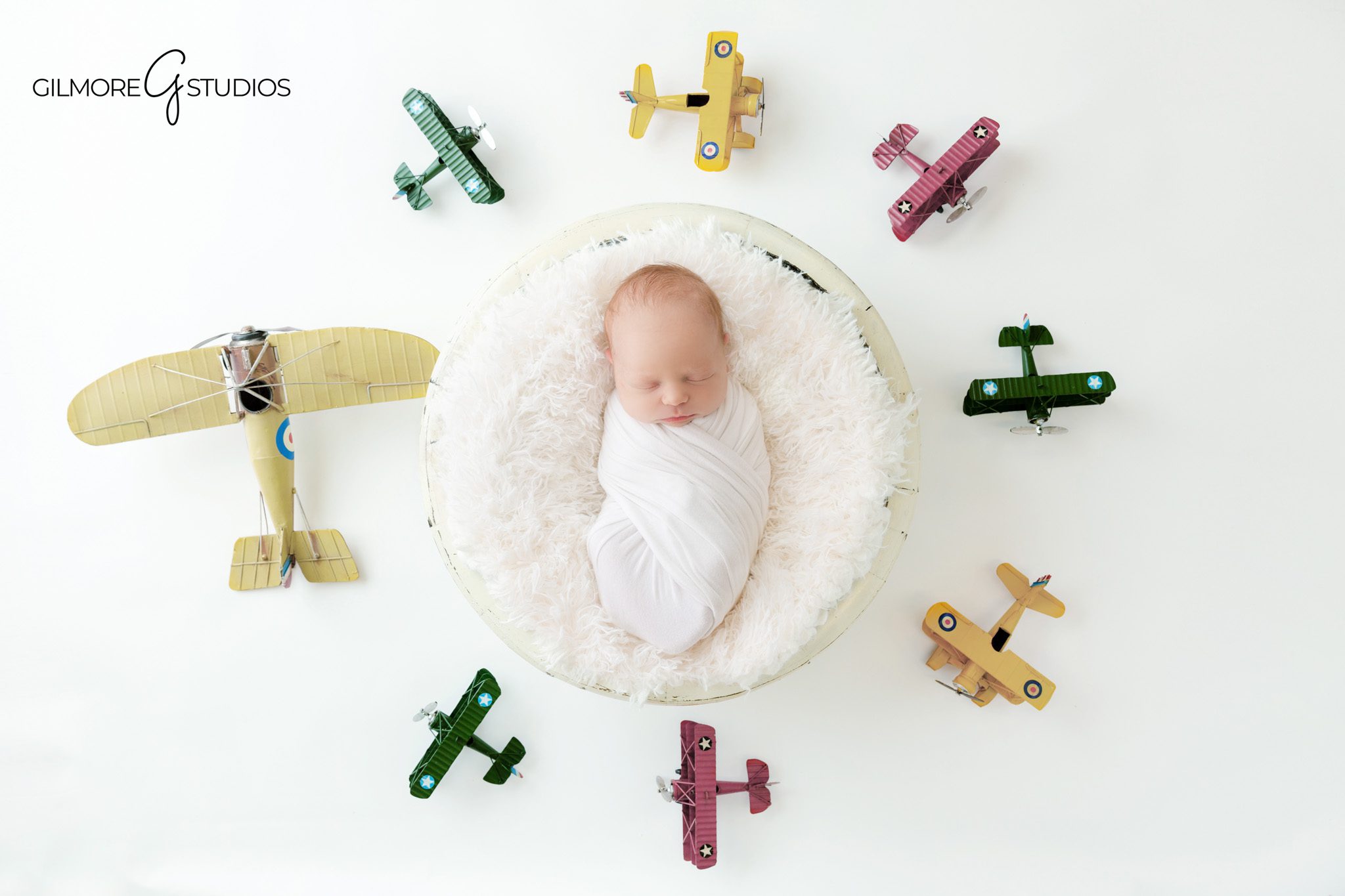 Queen Creek newborn photographer for vintage airplane themed baby photos
Vintage airplane newborn session with baby wrapped in white
